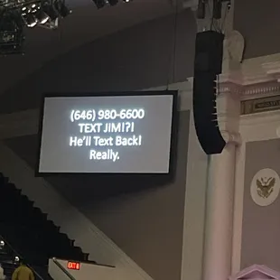 a large screen in the middle of the auditorium