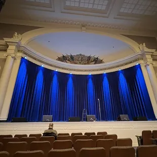 a stage with blue curtains