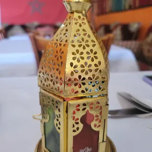 a gold lantern on a table