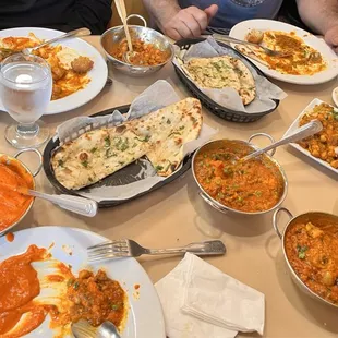 Garlic naan, daal, Chana masala, chicken tikka masala, paneer tikka masala, potato and peas.