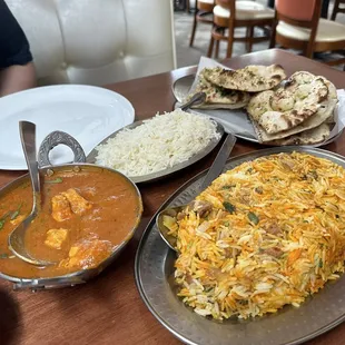 LAMB BIRYANI (GF) - on the right Chicken Curry with white rice - on the right  Garlic Naan - in the back