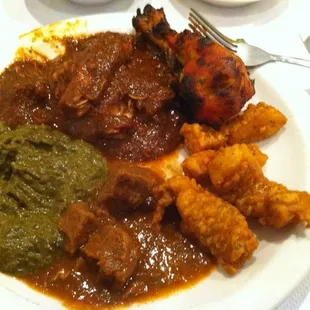 Clockwise: Tandoori chicken leg, Fish Pakora, Lamb Vindaloo, Saag, Chicken Vindaloo