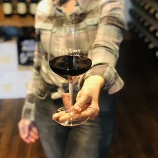 a woman holding a glass of wine