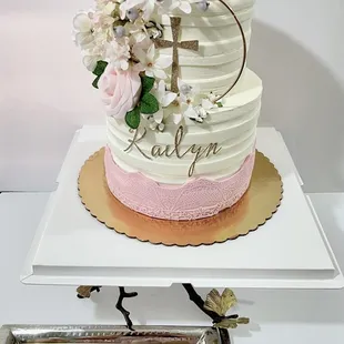 a three tiered cake and cookies