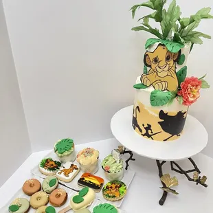 a decorated cake and cupcakes