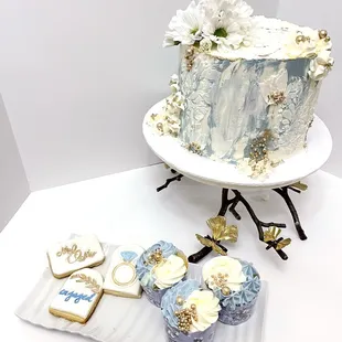 a decorated cake and cupcakes