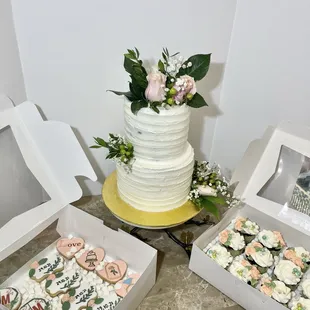 a wedding cake and cupcakes