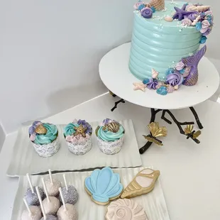 a mermaid cake and cupcakes