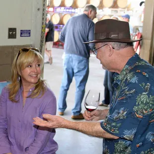 A wine club member enjoys chatting with Darcie at a Wine Club Release Party