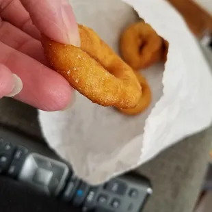 a hand holding a donut