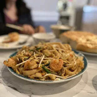 a bowl of noodles and a pie