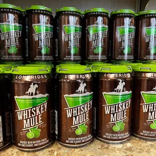 a shelf of whiskey mule cans