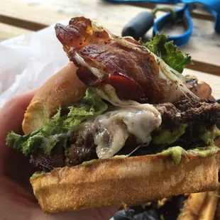 Bacon avocado burger action shot! Gooey tasty deliciousness!