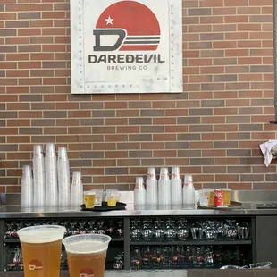 two glasses of beer on a bar