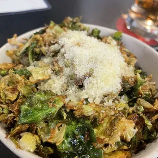 a bowl of brussels sprouts with parmesan cheese