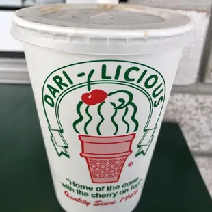 a cup of coffee with a cherry on top