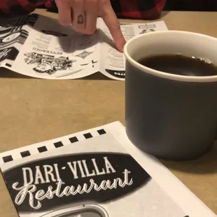 a cup of coffee and a menu