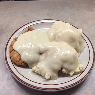 Fried chicken and potatoes and gravy.