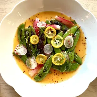 Charred pea pods and radishes