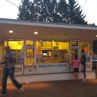 a man and a woman standing in front of a store