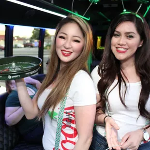 two women holding a tray of food