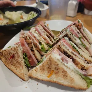 a plate of sandwiches and a bowl of salad
