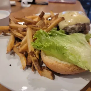 a burger and fries on a white plate