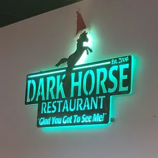 a neon sign for a dark horse restaurant