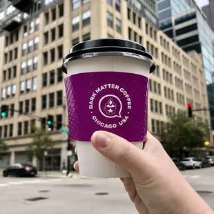 a hand holding a coffee cup