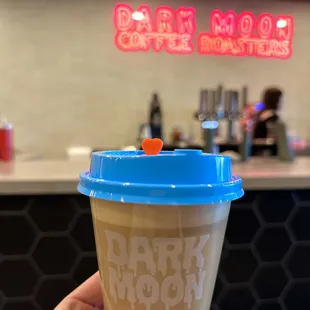 a hand holding a coffee cup