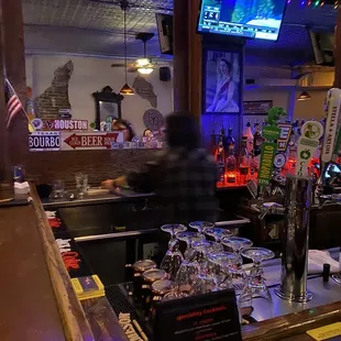 a bar with a lot of glasses on the counter