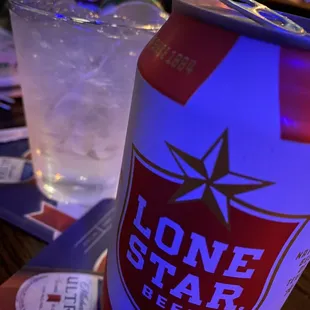 a can of lone star beer and a glass of water