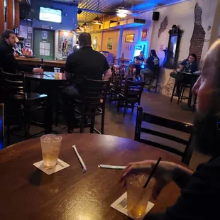 a man sitting at a table with a drink