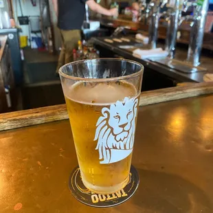 a pint of beer on a bar