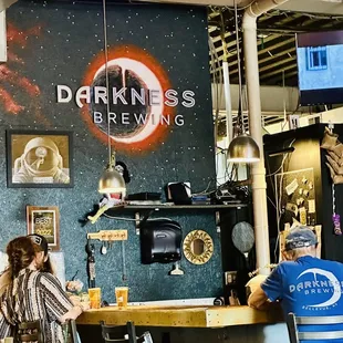 two people sitting at a bar