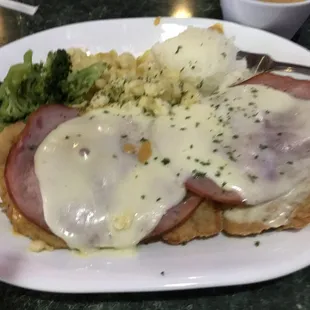 a plate of food with meat, mashed potatoes and broccoli