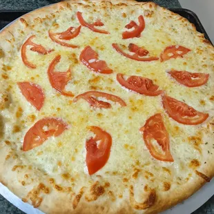 a pizza with tomatoes on it