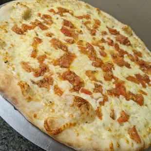 a large pizza with meat and cheese