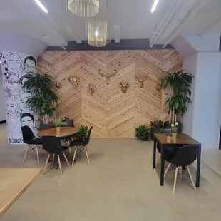 a dining area with a wooden wall