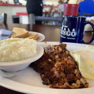 Eggs, corned beef hash and grits.