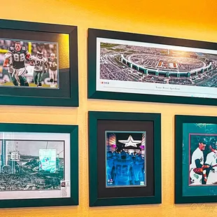 a wall of framed photos