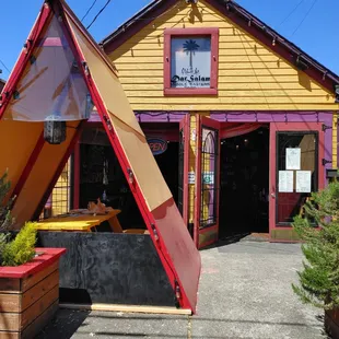 a yellow building with a red roof