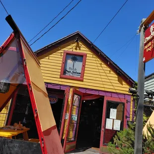 a yellow and red building with a red awning