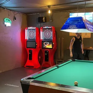 a pool table and arcade machines