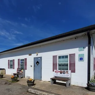 a white building with red shutters