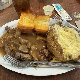 Beef tips, baked potato and rolls