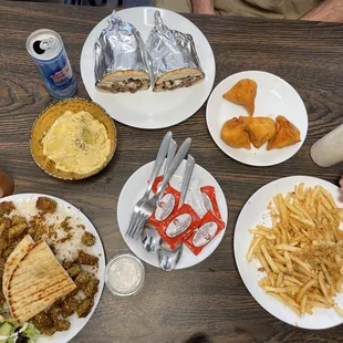 The spread--falafel plate, garlic fries, hummus, samosas, and stick cheese sandwich.