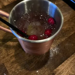 cranberries in a copper cup with chopsticks