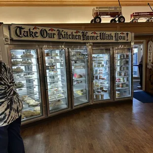 a woman standing in front of a display case