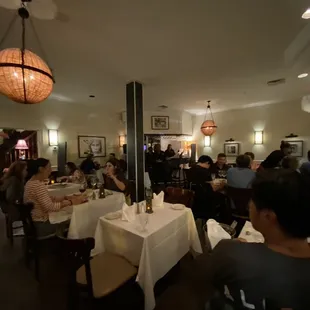 a group of people sitting at tables in a restaurant